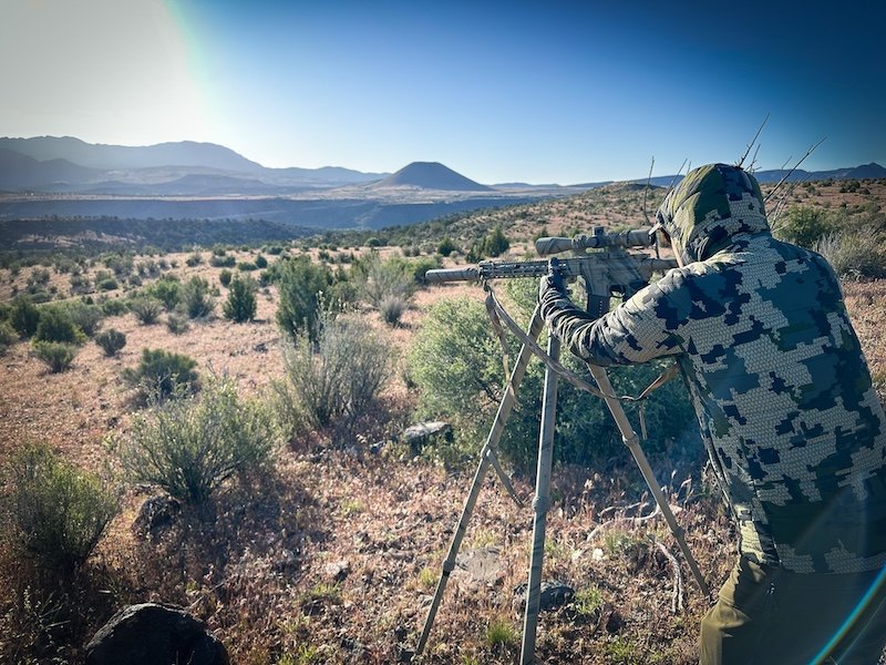 Coyote hunter on a tripod overlooking southern Utah desert